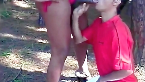 Ebony brunette plays with her black dildo outdoors