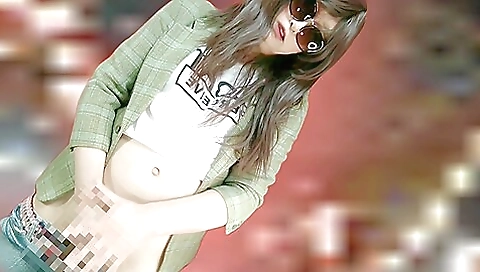 Asian shemale with a shaved pussy filled with a dildo